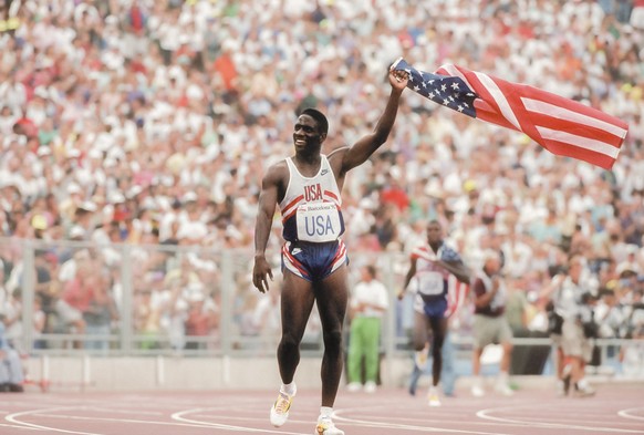 BARCELONA, SPAIN - AUGUST 8: Dennis Mitchell of the USA celebrates the USA team win of the Men&#039;s 4 x 100 meters relay event of the Athletics competition of the 1992 Summer Olympics on August 8, 1 ...