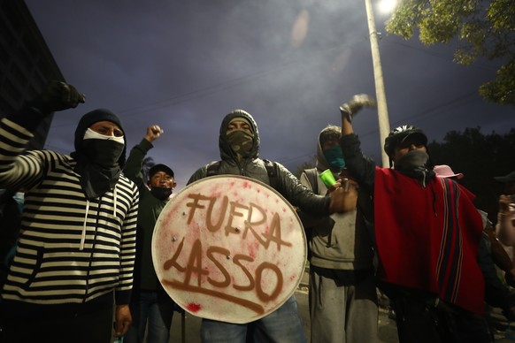 epa10030977 Demonstrators use shields to protect themselves during clashes with members of the police around the House of Culture in Quito, Ecuador, 23 June 2022. The center of Quito once again became ...