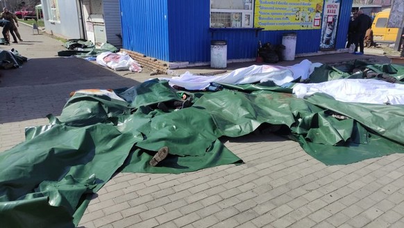 epa09878020 A handout picture made available by the Donetsk Regional State Administration shows covered bodies of casualties after a missile strike hit the railway station in Kramatorsk, Donbass regio ...