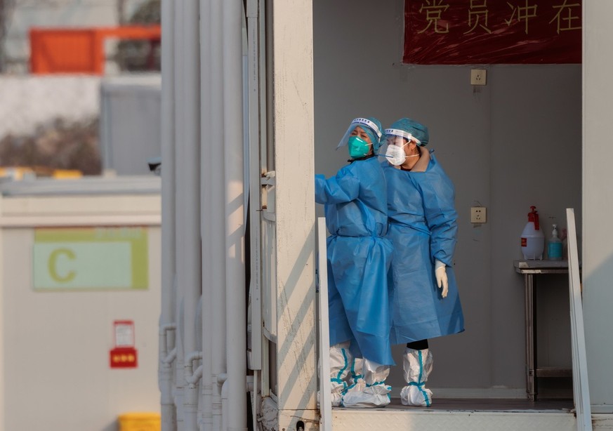 epa10379134 People stand in a temporary settlement for people with mild or no symptoms provided by Shanghai city due to the rising number of Covid-19 cases which offers rooms with bathrooms, air-condi ...