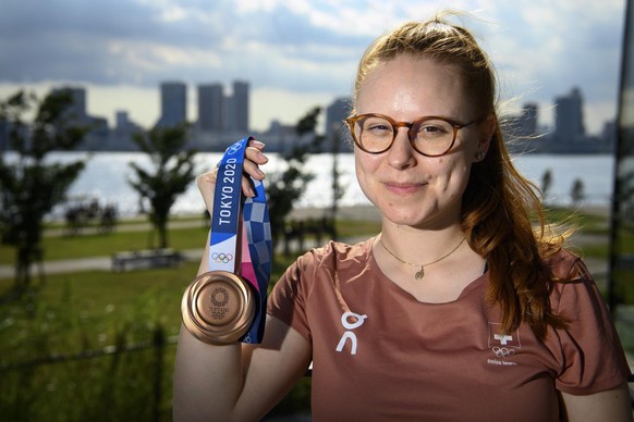 Nina Christen of Switzerland poses with her bronze medal before a virtual press conference after the women&#039;s shooting 10m air rifle finals at the 2020 Tokyo Summer Olympics in Tokyo, Japan, on Sa ...