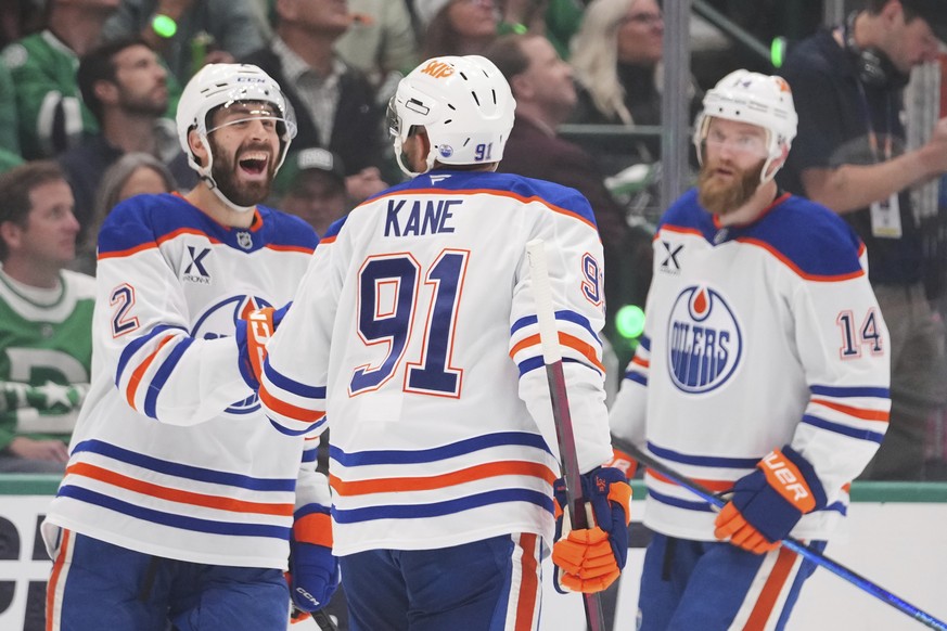 Edmonton Oilers left wing Evander Kane (91) celebrates with defenseman Evan Bouchard (2) and defenseman Mattias Ekholm (14) after scoring against the Dallas Stars during the third period of Game 5 of  ...