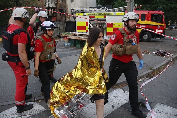 KYIV, UKRAINE - JULY 10: Red Cross medics evacuate a woman from a damaged residential building after a Russian drones and missiles attack on July 10, 2025 in Kyiv, Ukraine. At night, the Russian army  ...