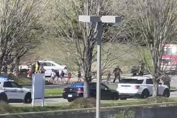 In this image from video provided by Jozen Reodica, law enforcement officers lead children away from the scene of a shooting at The Covenant School, a private Christian school in Nashville, Tenn., on  ...