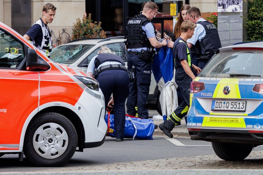 Members of the emergency services work at the scene where a car ploughed into people on a street leaving at least two dead and several injured, in the city centre in Leipzig, eastern Germany on May 4, ...