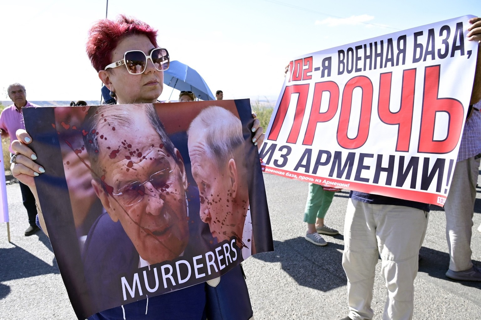 Armenian protesters hold placards reading &quot;Murderers&quot;, &quot;102nd military base out of Armenia!&quot; as they take part in a rally to protest against the presence of the 102nd Russian milit ...