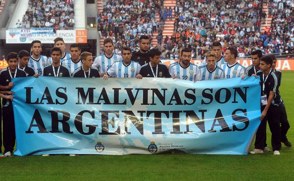 Argentina&#039;s team poses for a picture with a banner reading in Spanish &amp;quot;The Malvinas are Argentine&amp;quot; referring to the Malvinas Islands or the Falkland Islands before an internatio ...