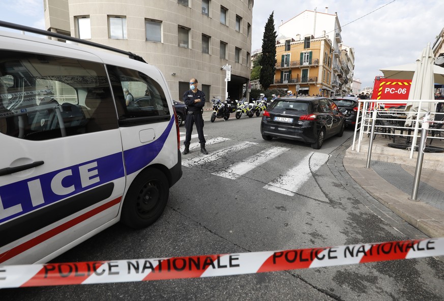 epa09570923 French police officers stand at a security perimeter following a knife attack in Cannes, France, 08 November 2021. According to French Internior Minister Gerald Darmanin, one police office ...