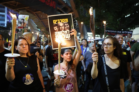 epa12291590 Families of Israeli hostages held by Hamas in Gaza and their supporters attend a protest calling on the government to sign a hostages release and ceasefire deal, outside the Kirya military ...