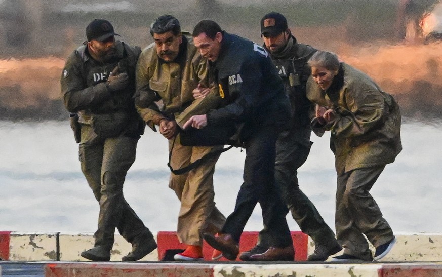 epa12628899 Captured Venezuelan President Nicolas Maduro and his wife, Cilia Flores, arrive at the Wall Street Heliport during their transport to the federal courthouse for their arraignment in New Yo ...