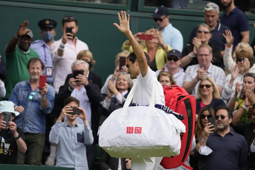 Switzerland&#039;s Roger Federer leaves the court after being defeated by Poland&#039;s Hubert Hurkacz during the men&#039;s singles quarterfinals match on day nine of the Wimbledon Tennis Championshi ...