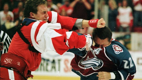 Detroit Red Wings' Darren McCarty, left, and Colorado Avalanche right wing Claude Lemieux, right, begin the game with a fight in the first period Tuesday, Nov. 11, 1997, in Detroit. Lemieux and M ...