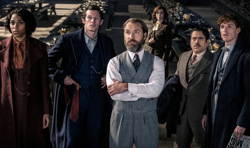 This image released by Warner Bros. Pictures shows, from left, Jessica Williams, Callum Turner, Jude Law, Fionna Glascott, Dan Fogler and Eddie Redmayne in a scene from &quot;Fantastic Beasts: The Sec ...