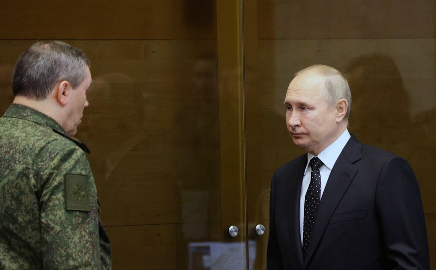 Russian President Vladimir Putin listens to Chief of the Russian General Staff Valery Gerasimov as he visits the joint staff of troops involved in Russia&#039;s military operation in Ukraine, at an un ...