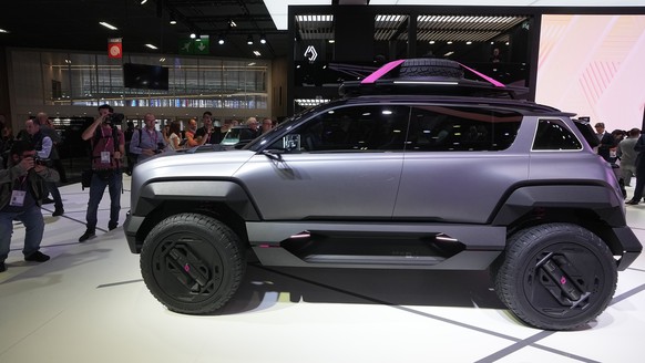 Visitors gather around the Renault 4Ever Trophy electric SUV concept car at the Paris Car Show Monday, Oct. 17, 2022 in Paris. Europe is leading the charge into electric vehicles as battery powered ca ...