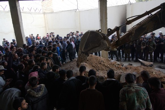 DAMASCUS, SYRIA - DECEMBER 9: People wait as Syrian Civil Defense teams carry out investigation in secret compartments of Sednaya Prison after the fall of the Assad regime in Damascus, Syria on Decemb ...