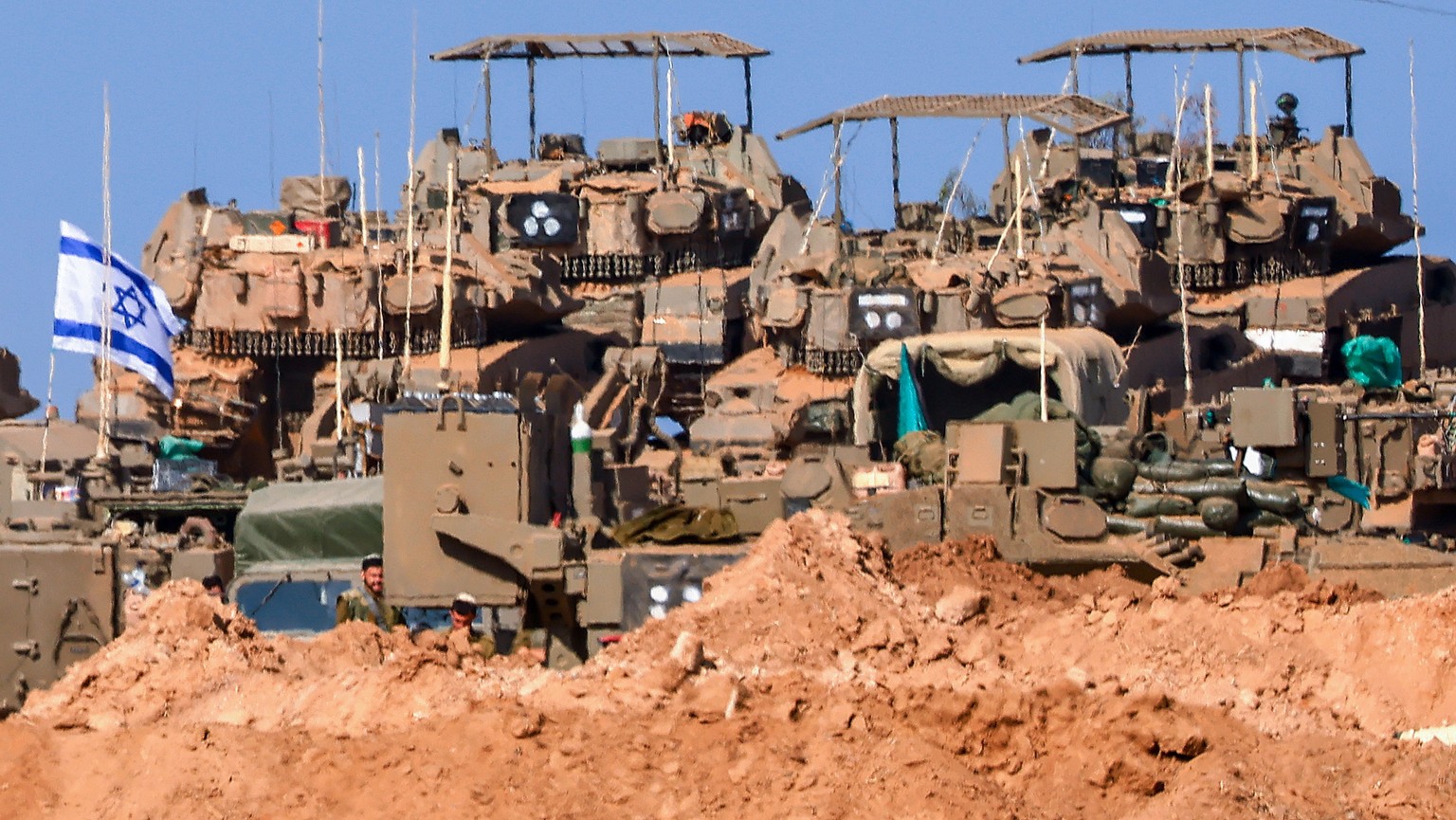 epa10928432 Israeli armored vehicles gathered at an undisclosed location near the border with Gaza, in Israel, 20 October 2023. More than 3,700 Palestinians and 1,400 Israelis have been killed accordi ...