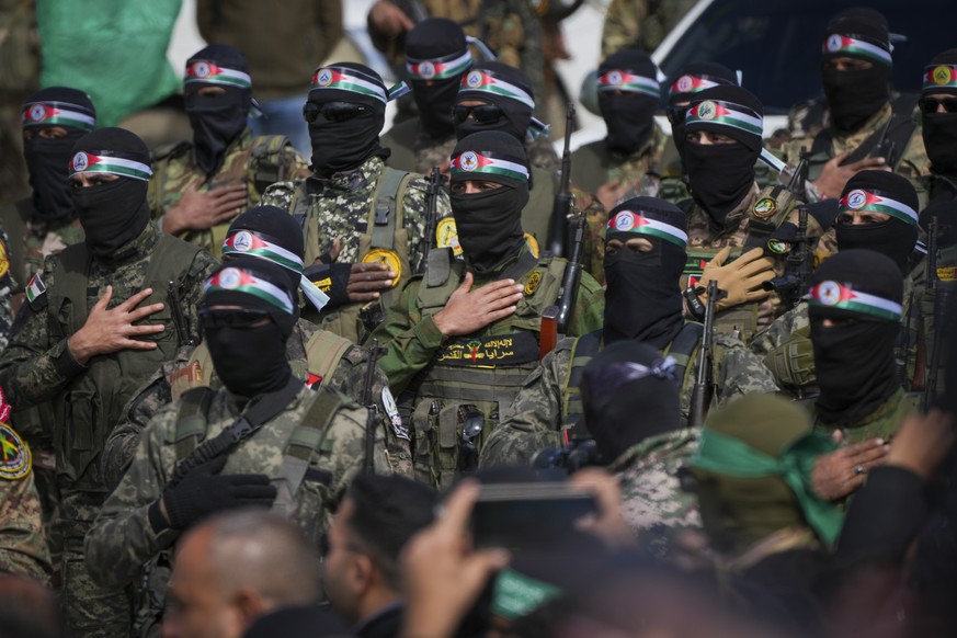 FILE - Hamas fighters stand in formation ahead of a ceremony to hand over Israeli hostages to the Red Cross in Nuseirat, Gaza Strip, Feb. 22, 2025. (AP Photo/Abdel Kareem Hana, File)
Palestinians Poli ...