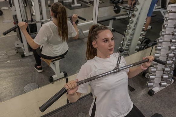Violetta Dezhyna, 21, who works for the local administration, exercise in a gym in the town of Izium, in the eastern Kharkiv region on July 28, 2026, amid the Russian invasion of Ukraine. In Izium, Uk ...