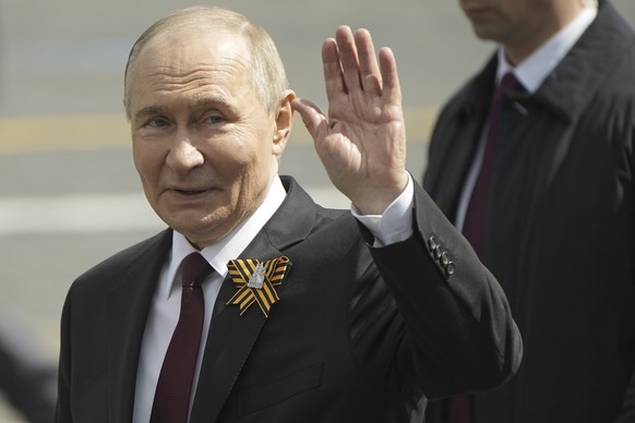Russian President Vladimir Putin gestures as he walks in Red square after the Victory Day military parade in Moscow, Russia, Friday, May 9, 2025, during celebrations of the 80th anniversary of the Sov ...