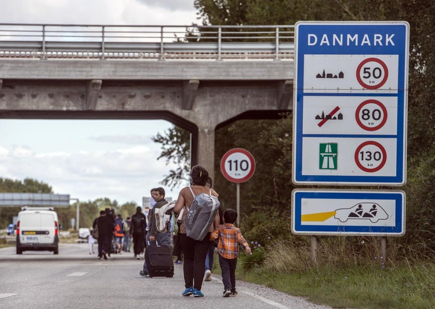 Migrants, who came from Germany by ferry and train Sunday night, walk from Rodby in southern Denmark towards Sweden on Monday Sept. 7, 2015. Most of the migrants came from Syria, and wished to continu ...