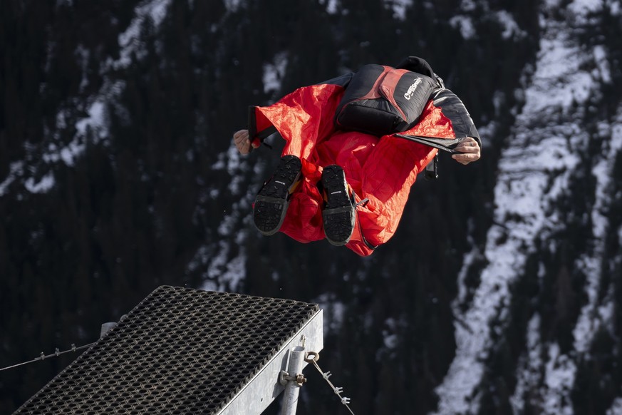 A base jumper with a wingsuit leaping off a platform to the valley, below Muerren, in the Lauterbrunner region of the Bernese Oberland, Switzerland, on December 17, 2024. (KEYSTONE/Anthony Anex)