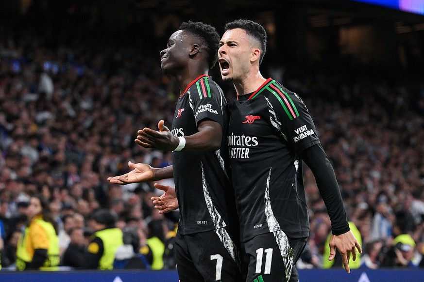 MADRID, SPAIN - APRIL 16: Bukayo Saka of Arsenal celebrates scoring his team&#039;s first goal with teammate Gabriel Martinelli during the UEFA Champions League 2024/25 Quarter Final Second Leg match  ...