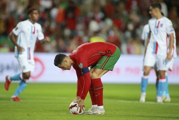 Portugal&#039;s Cristiano Ronaldo places the ball to take a penalty kick and score the opening goal during the World Cup 2022 group A qualifying soccer match between Portugal and Luxembourg at the Alg ...