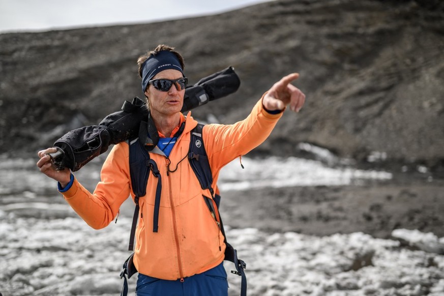 Glaciologist Matthias Huss, head of the "Glacier Monitoring in Switzerland" (GLAMOS) network, gestures during a visit to record changes in the melting Scex Rouge glacier, above Les Diableret ...