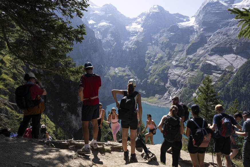 epa12291325 Tourists walk above the Oeschinen Lake (Oeschinensee), located at 1,578 meters above sea level, on a very hot summer day, above Kandersteg, in the Bernese Oberland, Switzerland, 09 August  ...