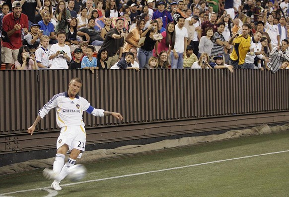 With fans cheering and snapping photos, Los Angeles Galaxy defender David Beckham kicks a corner kick during the second half against Sydney FC at the Pan-Pacific Championship soccer tournament at Aloh ...