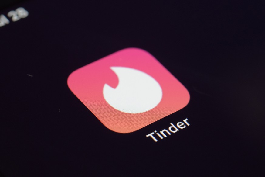 FILE - The icon for the Tinder dating app appears on a device in New York on July 28, 2020. Whether looking for love or a casual encounter, 3 in 10 U.S. adults say they have used a dating site or app. ...