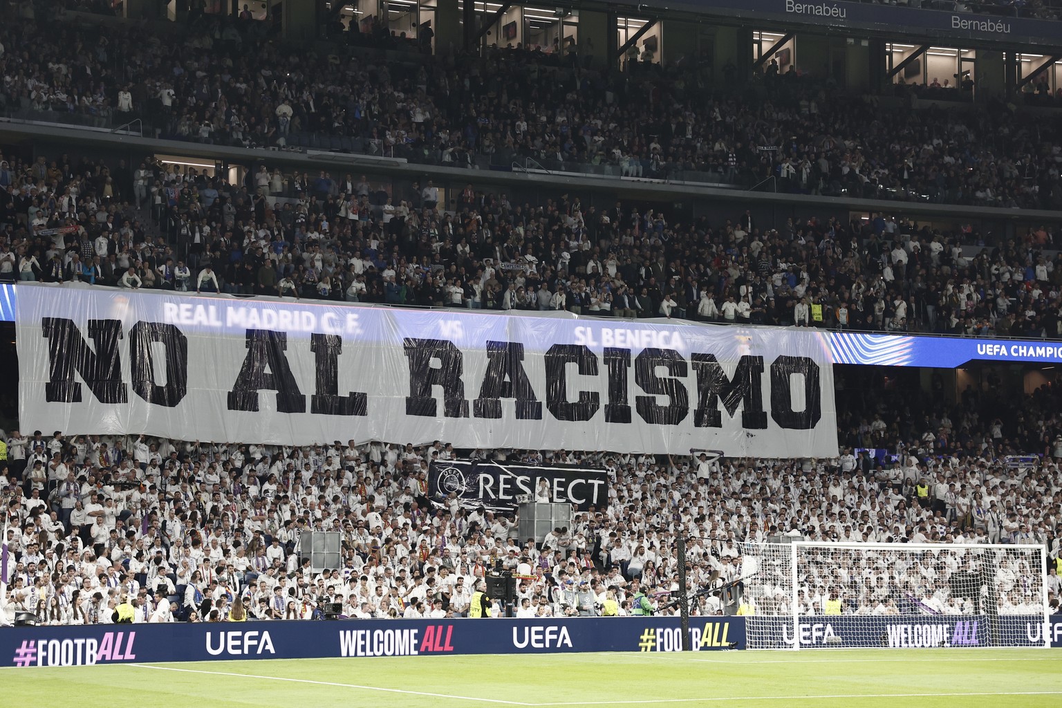 epa12776891 Real Madrid fans hold a banner with the slogan 'No to racism' during the Champions League play-offs second leg soccer match between Real Madrid and Benfica in Madrid, Spain, 25 F ...