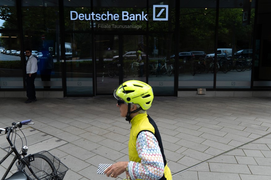 epa13126208 A cyclist parks their bicycle outside the Deutsche Bank central headquarters in Frankfurt, Germany, 22 July 2026. Germany's largest commercial bank, Deutsche Bank, confirmed that its  ...