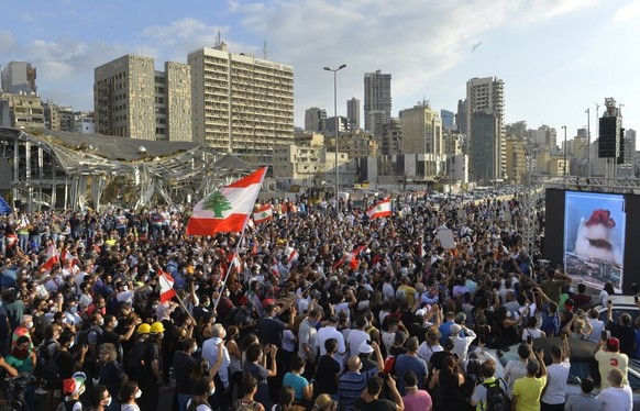 BEIRUT, LEBANON - AUGUST 11: Lebanese demonstrators gather to march towards the parliament building following the resignation of Lebanese government, during the fourth day of the demonstration after a ...