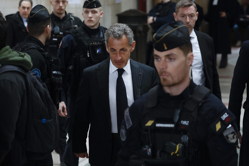 epa11152095 Former French President Nicolas Sarkozy (C) arrives to the courthouse to attend a hearing in his appeal trial at the Justice Palace in Paris, France, 14 February 2024. Sarkozy appeals a on ...