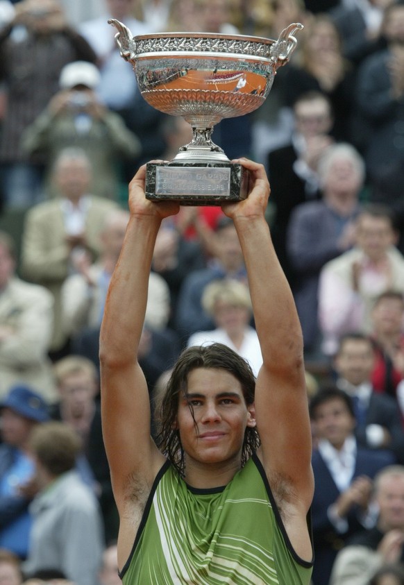 Spain&#039;s Rafael Nadal holds the trophy after defeating Argentina&#039;s Mariano Puerta in their final of the French Open tennis tournament, at the Roland Garros stadium, Sunday, June 5, 2005 in Pa ...