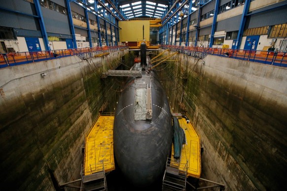 (FILES) This file photograph shows a submarine at the Ile Longue Defence unit, a submarine navy base, in Crozon, near Brest, western France, on July 4, 2017. Emmanuel Macron will deliver from the Ile  ...