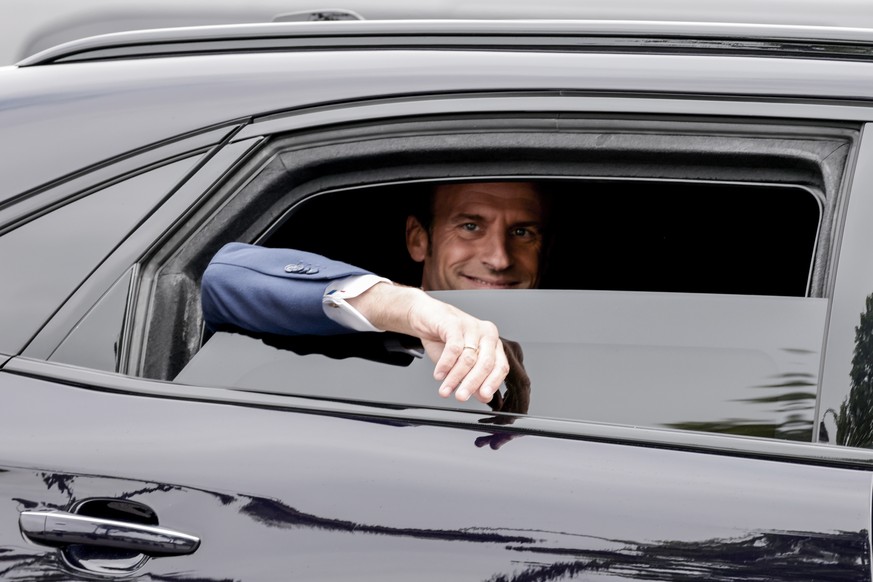 epa09933331 France&#039;s President Emmanuel Macron waves from his car as he leaves during the ceremonies marking the Allied victory against Nazi Germany and the end of World War II in Europe (VE Day) ...