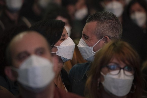 People using face masks take part in a music concert in Barcelona, Spain, Saturday, March 27, 2021. Five thousand music lovers are set to attend a rock concert in Barcelona on Saturday after passing a ...