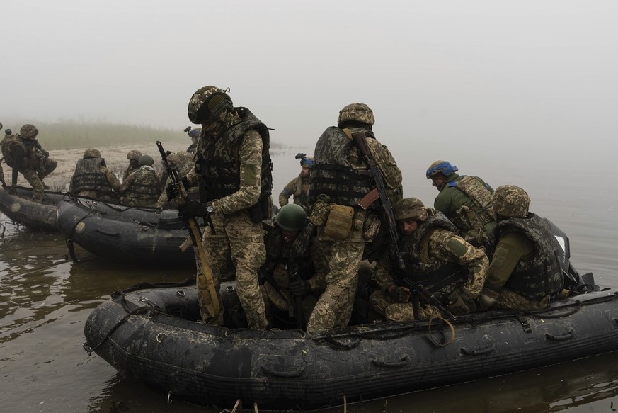 A group of Ukrainian marines sail from the riverbank of Dnipro at the frontline near Kherson, Ukraine, Saturday, Oct. 14, 2023. (AP Photo/Alex Babenko)