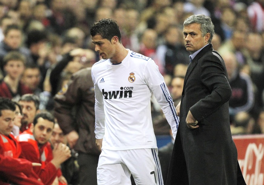 Real Madrid's Cristiano Ronaldo from Portugal, left, celebrates with coach Jose Mourinho form Portugal during a Spanish La Liga soccer match against Atletico Madrid at the Vicente Calderon stadiu ...