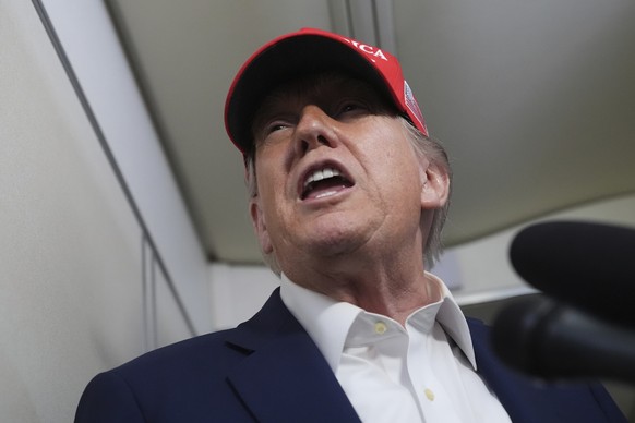 President Donald Trump speaks to reporters on board Air Force One, en route from Joint Base Andrews, Md., to Morristown Municipal Airport in Morristown, N.J., Friday, July 4, 2025. (AP Photo/Jacquelyn ...