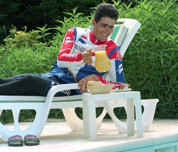Tour de France overall leader Miguel Indurain of Spain looks for a glass to enjoy some orange juice by the swimming pool of his hotel in Saint-Girons, southern France Monday morning July 17, 1995. Tou ...