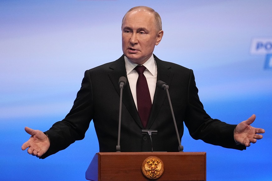Russian President Vladimir Putin gestures while speaking on a visit to his campaign headquarters after a presidential election in Moscow, Russia, early Monday, March 18, 2024. (AP Photo/Alexander Zeml ...