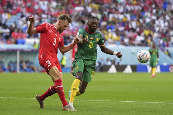 Switzerland&#039;s Silvan Widmer, left, is challenged by Cameroon&#039;s Karl Toko Ekambi during the World Cup group G soccer match between Switzerland and Cameroon, at the Al Janoub Stadium in Al Wak ...