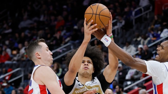 Kyshawn George (au centre) et les Wizards ont réussi leur coup dans le Michigan.