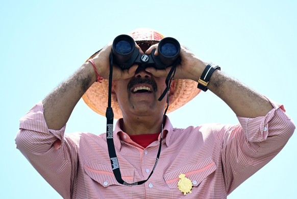 (FILES) Venezuelan President and presidential candidate Nicolas Maduro looks through binoculars during his campaign closing rally in Maracaibo, Zulia State, Venezuela, on July 25, 2024, ahead of Sunda ...