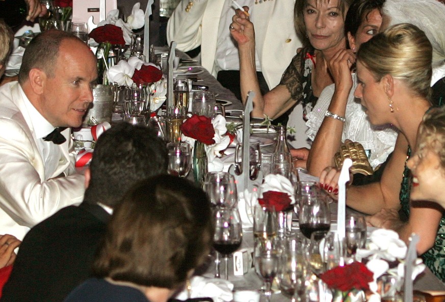Prince Albert II of Monaco, left, speaks with his guest Charlene Wittstock, in green, at the &quot;Monte-Carlo Red Cross Gala&quot;, Friday, Aug. 4, 2006, in Monaco. Wittstock is a South African Olymp ...