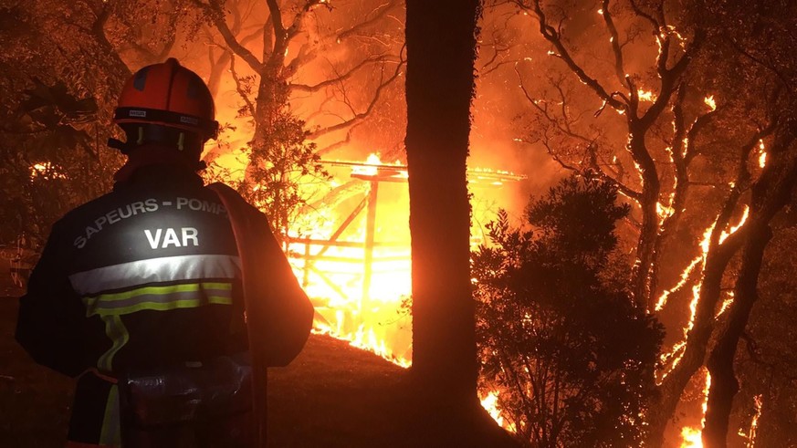 epa09417790 A handout photo made available by the French Securite Civile show firefighters trying to exinguish a fire in the Var department, southern France, 17 August 2021. Firefighters are battling  ...
